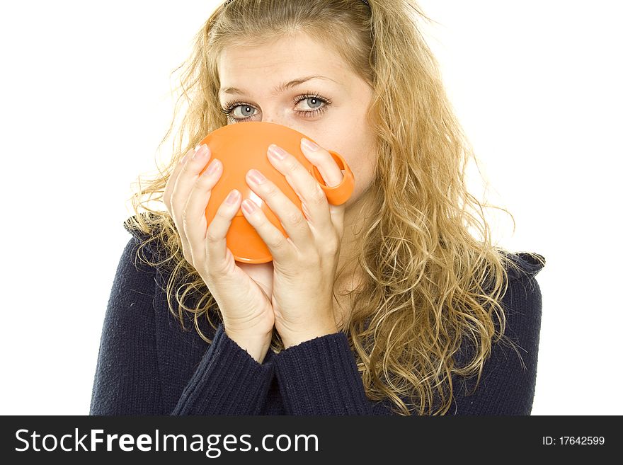 Pretty young woman with an orange cup of tea / coffee. Lots of copyspace and room for text on this isolate. Pretty young woman with an orange cup of tea / coffee. Lots of copyspace and room for text on this isolate