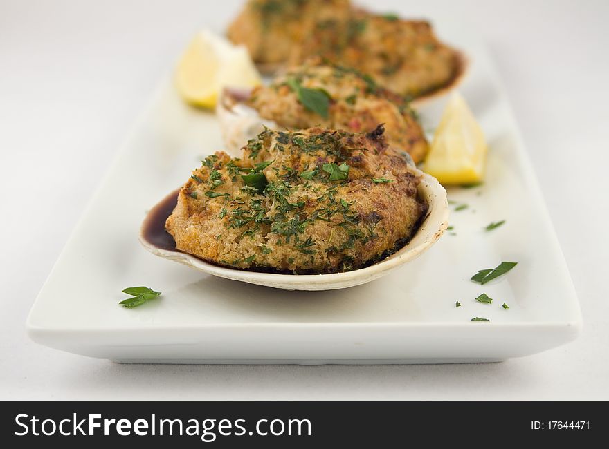 Stuffed clams appetizer with lemon garnish