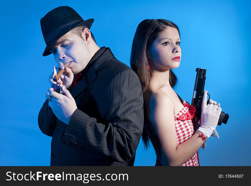Young couple dressed elegant playing as bonnie and clyde