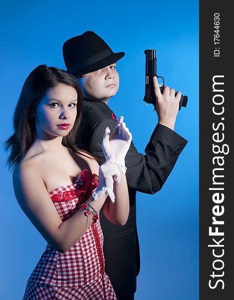 Young couple dressed elegant playing as bonnie and clyde