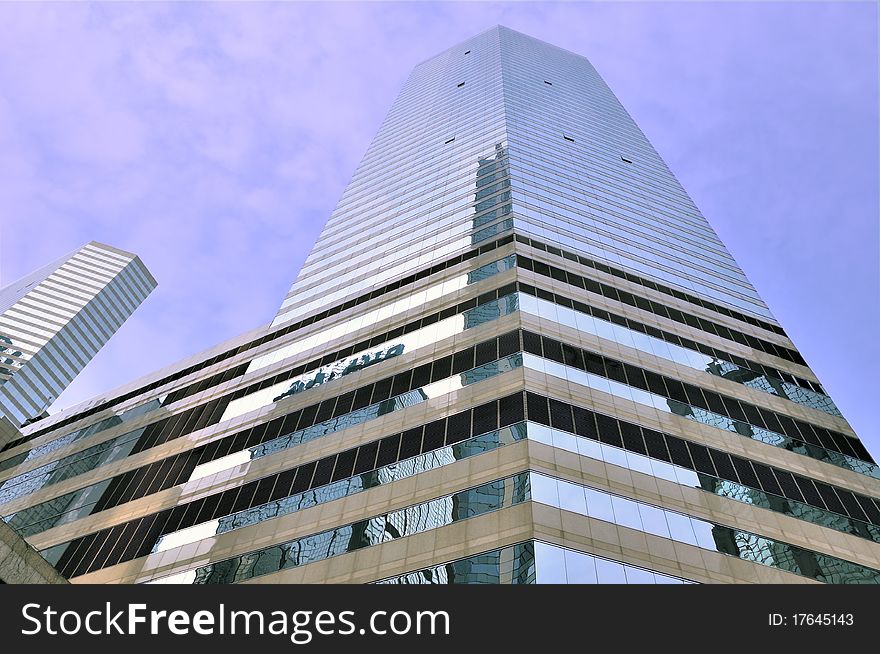 Modern buildings in Hongkong, under blue sky, with glass external and reflection, means business developing and urban environment. Modern buildings in Hongkong, under blue sky, with glass external and reflection, means business developing and urban environment.