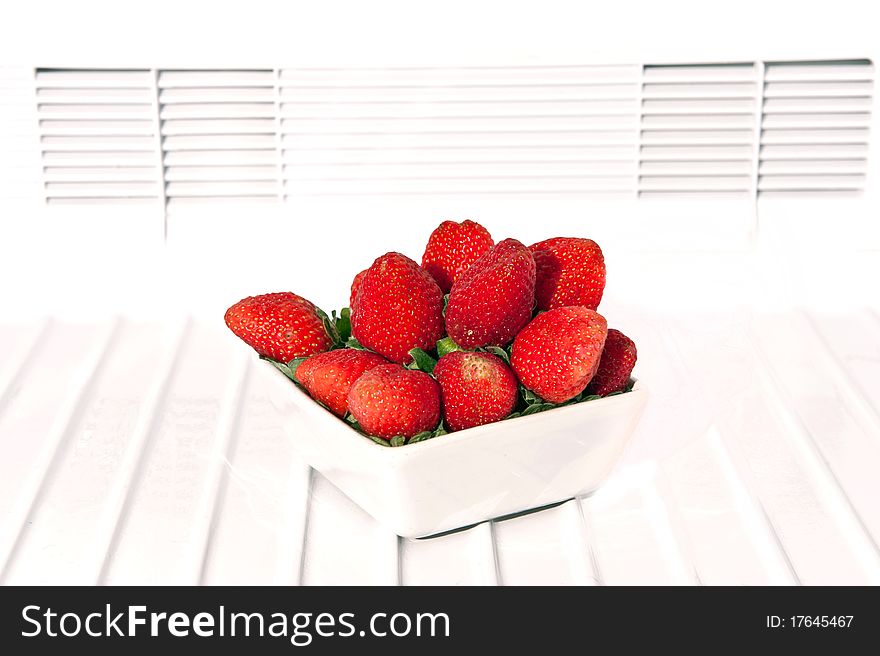 Fresh strawberry in white bowl isolated on white. Fresh strawberry in white bowl isolated on white