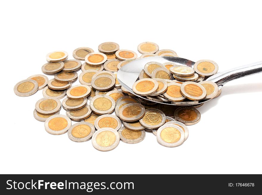 Coins and the spoon in a plate on a white background. Coins and the spoon in a plate on a white background