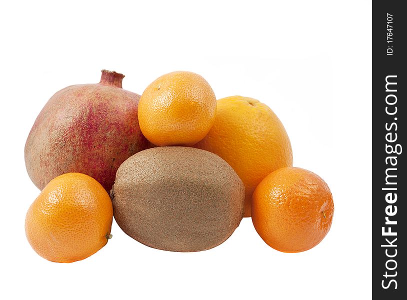 Pomegranate, kiwi, tangerines and oranges on a white background