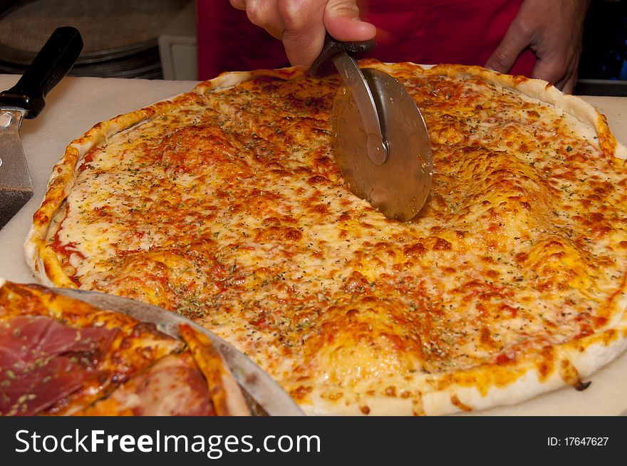 Cutting Pizza in Slices at the restaurant