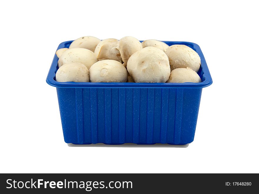 Fresh mushrooms in blue plastic box, isolated on white.Clipping paths of mushrooms and shadow on separete included.Easy work with. Fresh mushrooms in blue plastic box, isolated on white.Clipping paths of mushrooms and shadow on separete included.Easy work with.