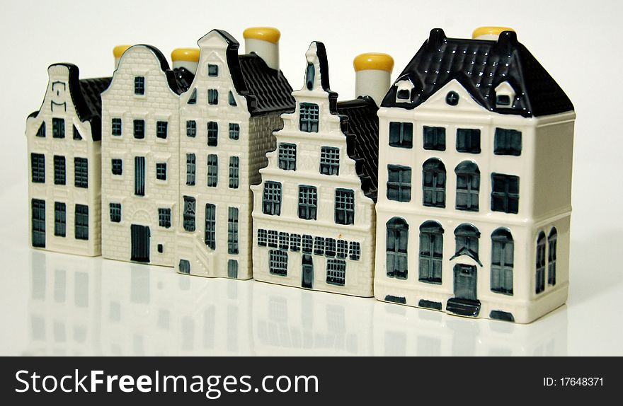 Row of five Dutch ceramic spirit bottles in the form of canalside homes, showing controlled depth of field. Row of five Dutch ceramic spirit bottles in the form of canalside homes, showing controlled depth of field