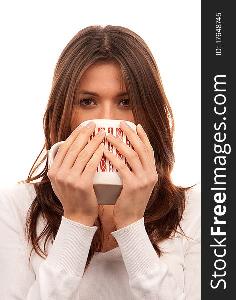 Pretty young woman holding red pattern mug of tea / coffee in hands isolated on white background. Pretty young woman holding red pattern mug of tea / coffee in hands isolated on white background