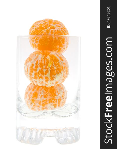 A little cleared the tangerines, lying in a glass  (on a white background, focus on tangerines). A little cleared the tangerines, lying in a glass  (on a white background, focus on tangerines)