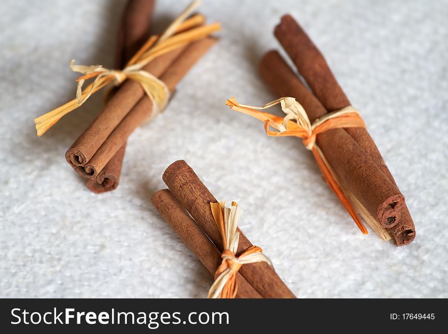 Pieces of cinnamon with a bow of raw paper
