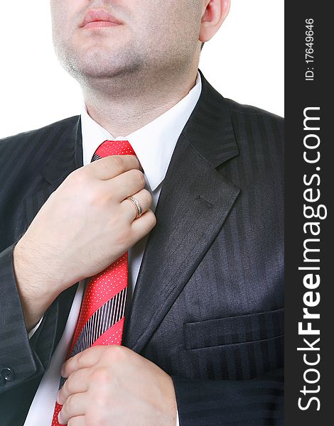 The businessman in a black suit corrects hands a tie. The businessman in a black suit corrects hands a tie