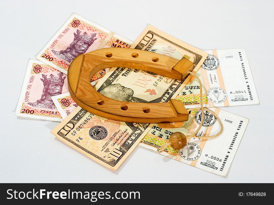 Wooden souvenir horseshoe is on the banknotes superstition luck omen. Wooden souvenir horseshoe is on the banknotes superstition luck omen