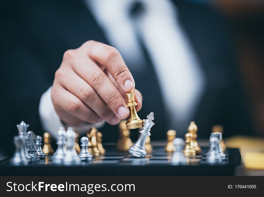 Hand Of Businessman Moving Chess Figure In Competition Success Play. Strategy, Management Or Leadership Concept