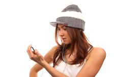 Female Lookin At Cell Phone In Headphones Stock Image