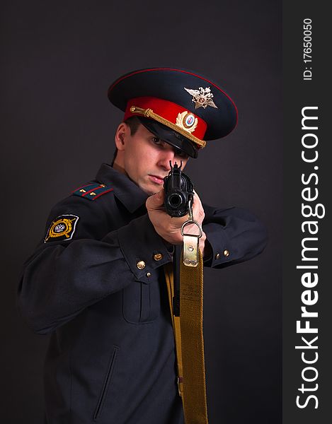Police officer in uniform with a gun