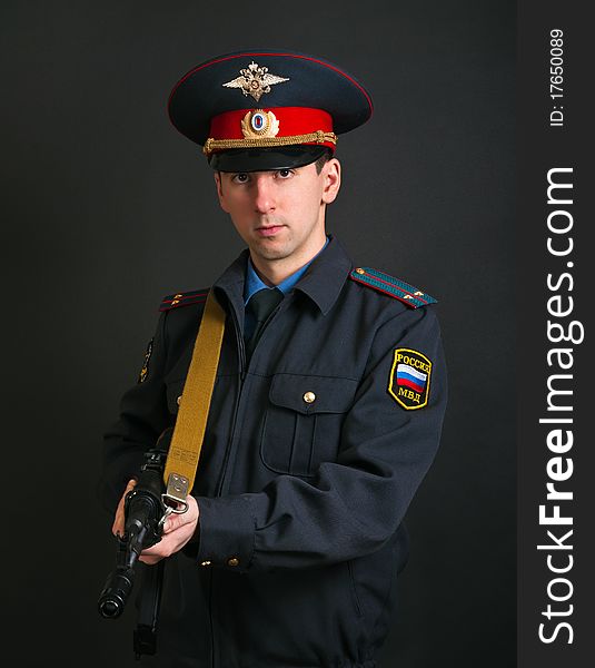 Police officer in uniform with a gun. Police officer in uniform with a gun