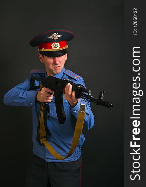 Police officer in uniform with machine gun AK-47. Police officer in uniform with machine gun AK-47