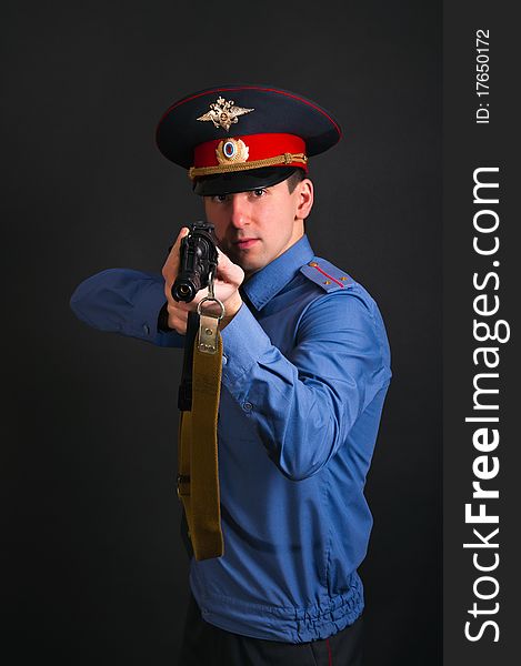 Police officer in uniform with machine gun AK-47