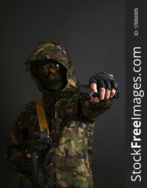 Soldier holding a machine gun AK-47 and pistol. Soldier holding a machine gun AK-47 and pistol