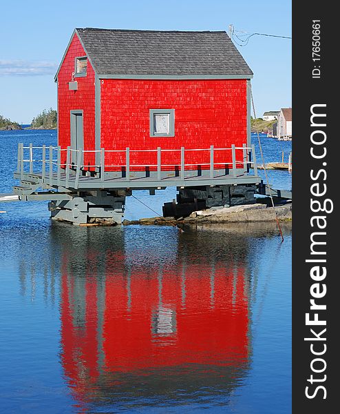 A red building is reflected in the water. A red building is reflected in the water