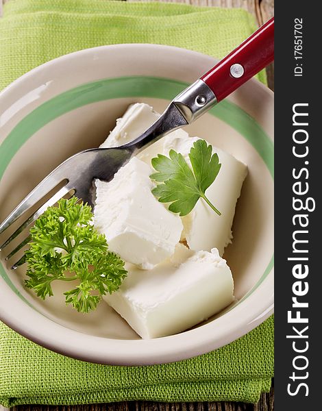 Blocks of fresh cheese in a bowl