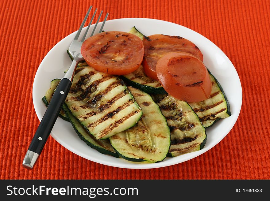 Grilled vegetables with fork on a plate