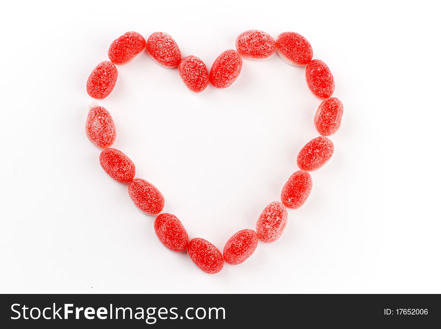Red candy sweets arranged to form a valentine heart shape. Red candy sweets arranged to form a valentine heart shape