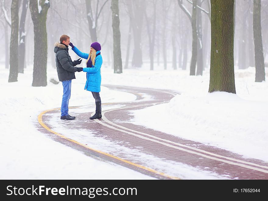 Young adult couple in the park. Winter.