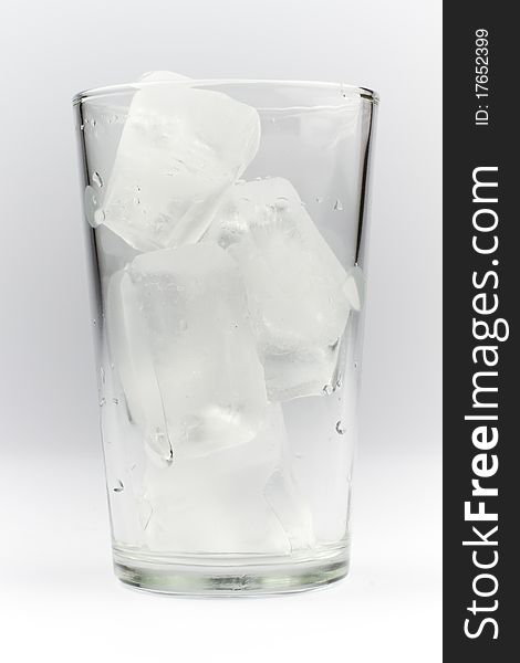 Drinking glass filled with ice cubes. Drinking glass filled with ice cubes