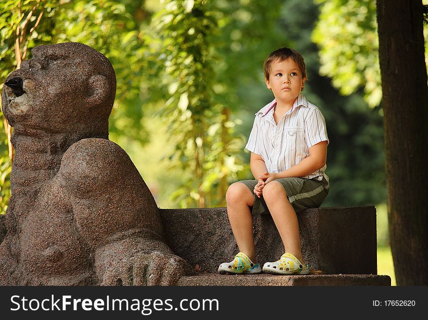 Little boy sitting in park. Little boy sitting in park