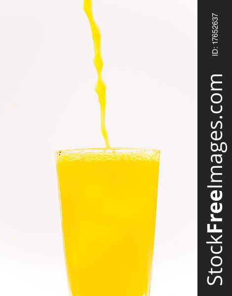 Yellow juice poured into a glass