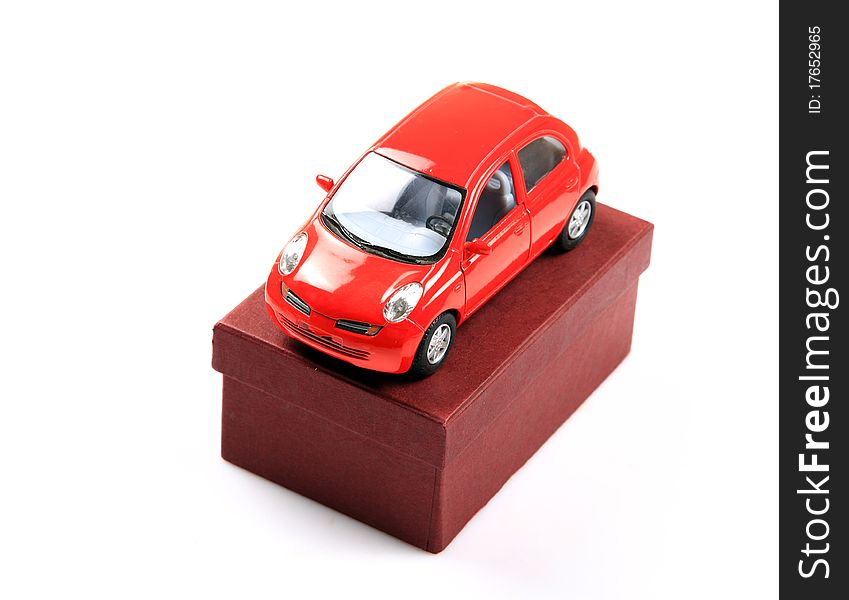 Red car model on box isolated on white background.