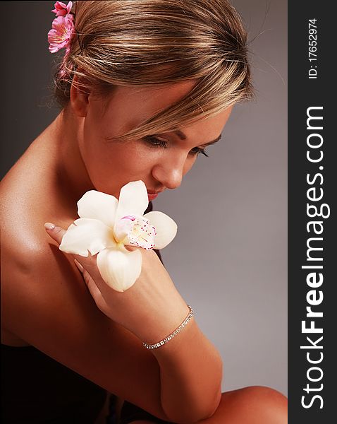 Beautiful thoughtful woman with white orchid