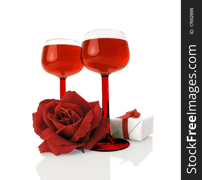 Red wine with a silk rose and a little gift on white. Red wine with a silk rose and a little gift on white