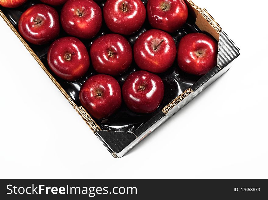 Box of fresh red apples isolated on white background