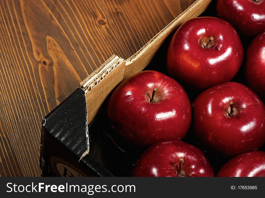 Close-up of Box of fresh apples on wood desk