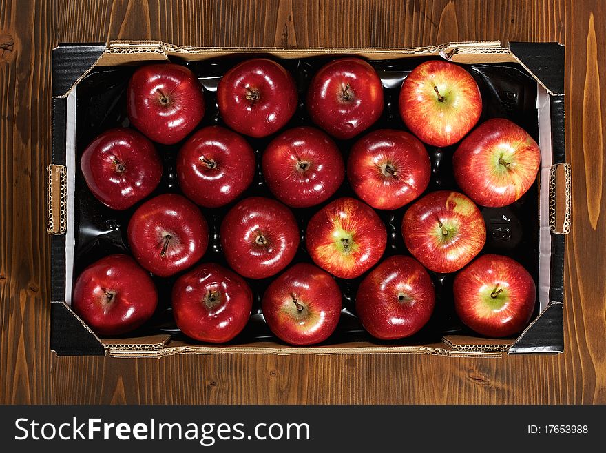 Box of fresh apples on wood desk