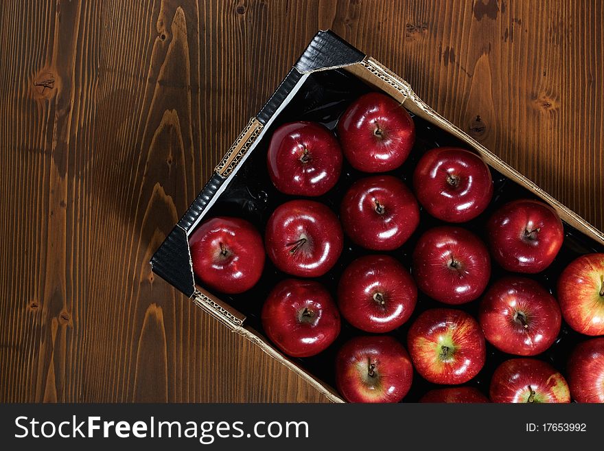 Close-up of Box of fresh apples on wood desk