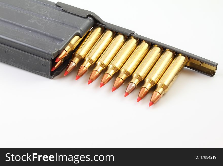 A strippe clip with bullets being lOaded into a magazine. A strippe clip with bullets being lOaded into a magazine.