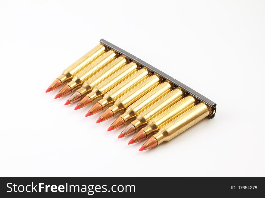 A row of .223 bullets on a stripper clip. A row of .223 bullets on a stripper clip.