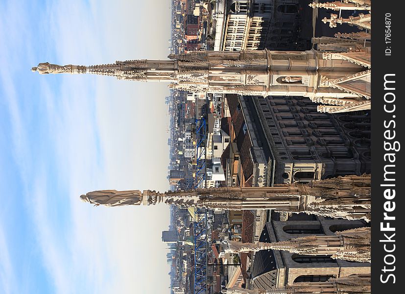 View of Duomo square and Milan roofs from the rooftop of Duomo Cathedral. View of Duomo square and Milan roofs from the rooftop of Duomo Cathedral.