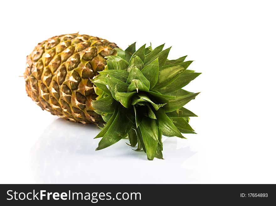Pineapple laying on white background with reflection