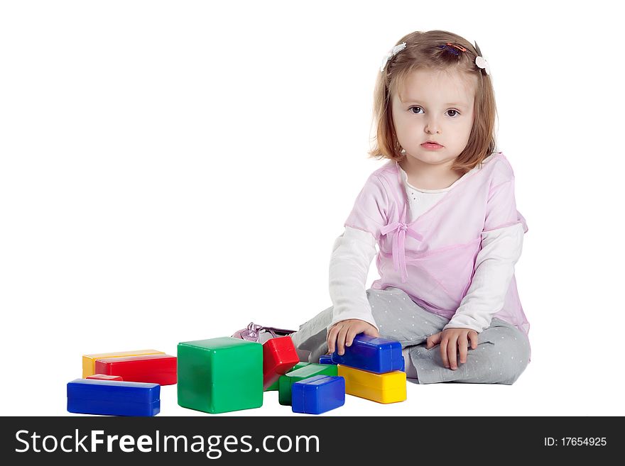 Little girl playing with cubes isolated