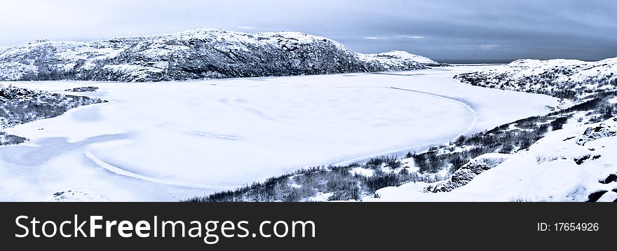 Frozen lake in Kola Peninsula close to Barents Sea (Russia) in early Winter. Frozen lake in Kola Peninsula close to Barents Sea (Russia) in early Winter