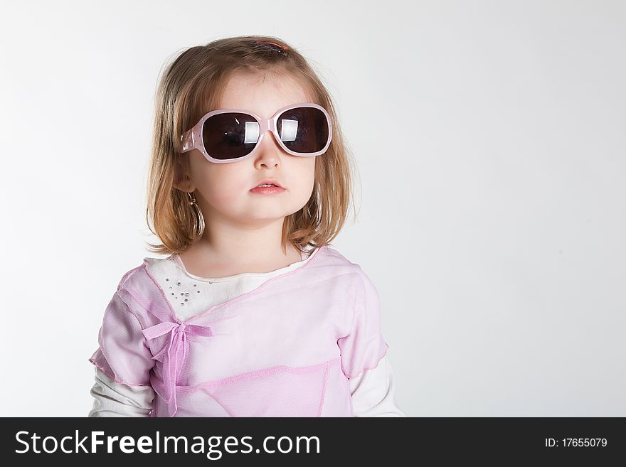 Little girl in sunglasses studio photo