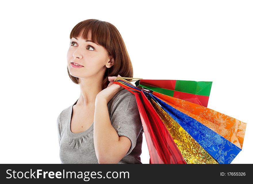 Pensive young woman with colored shopping bags, isolated on white. Pensive young woman with colored shopping bags, isolated on white