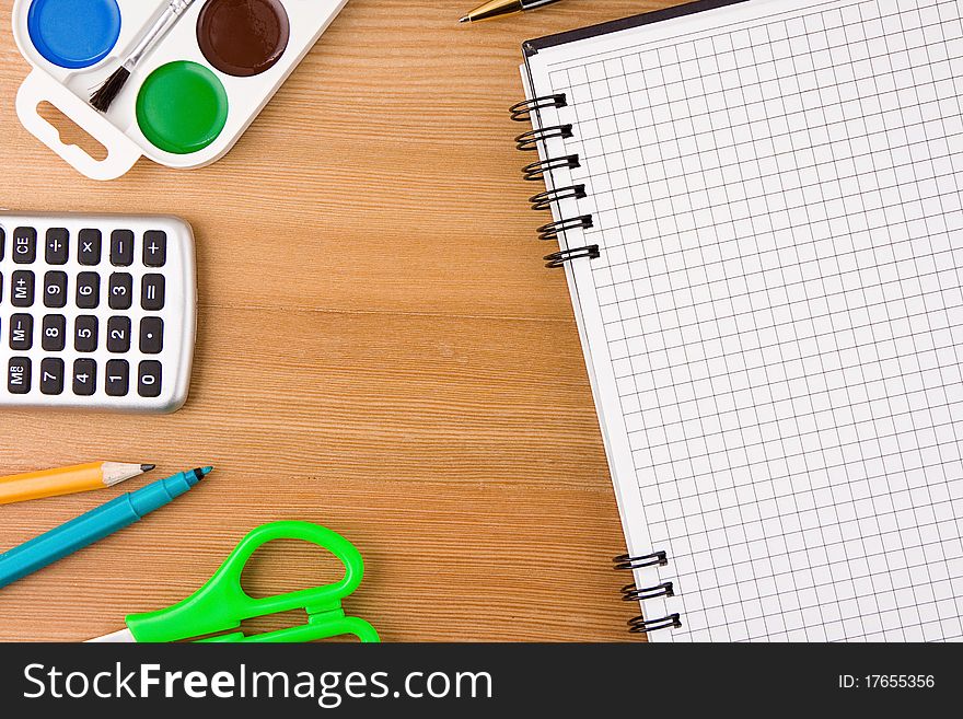 School Accessories And Checked Notebook On Wood