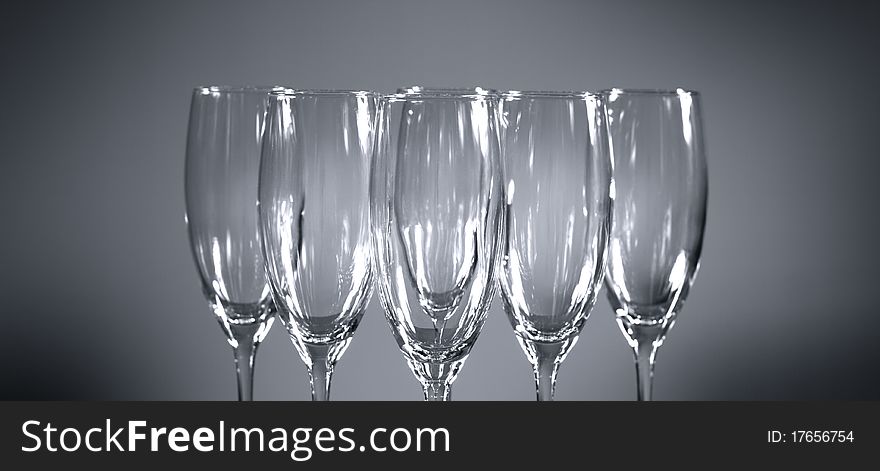 Empty champagne glasses on gray background