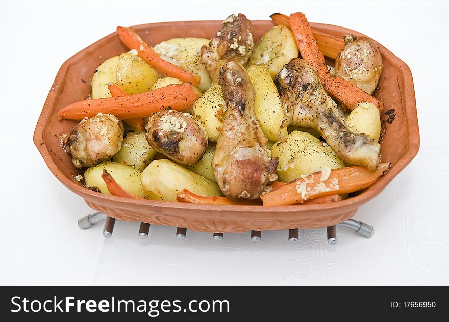 Roasted chicken and potatoes on a pot