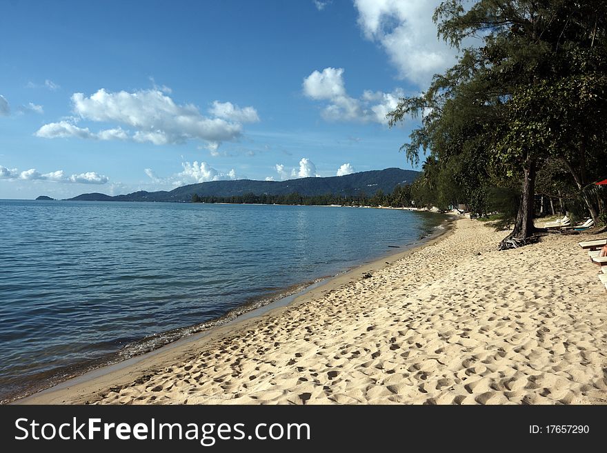 View of a tropical beach with mountains , image was taken in Thailand